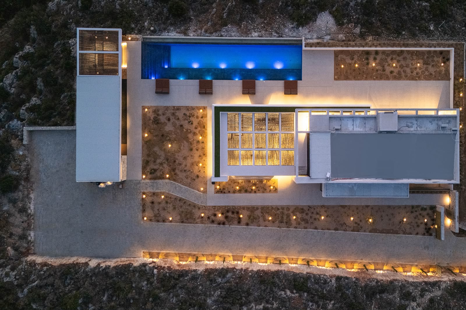 Villa KORA illuminated from above at night
