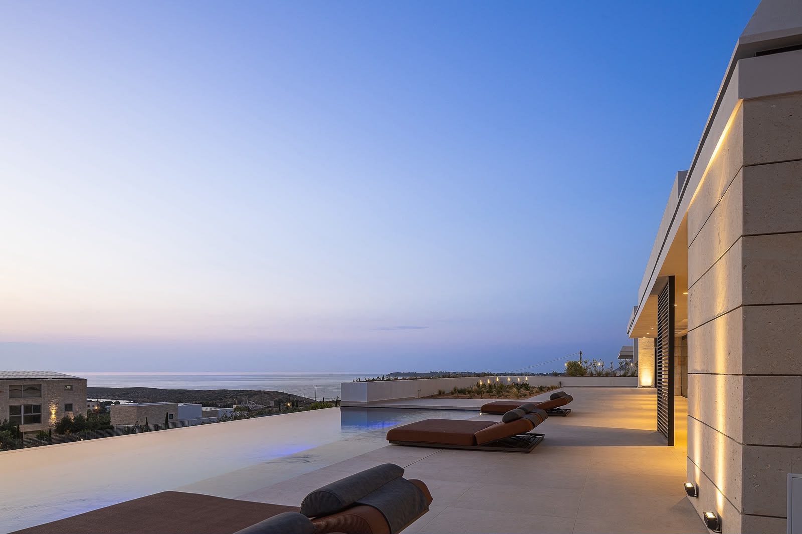 Infinity pool beneath the blue-hour sky