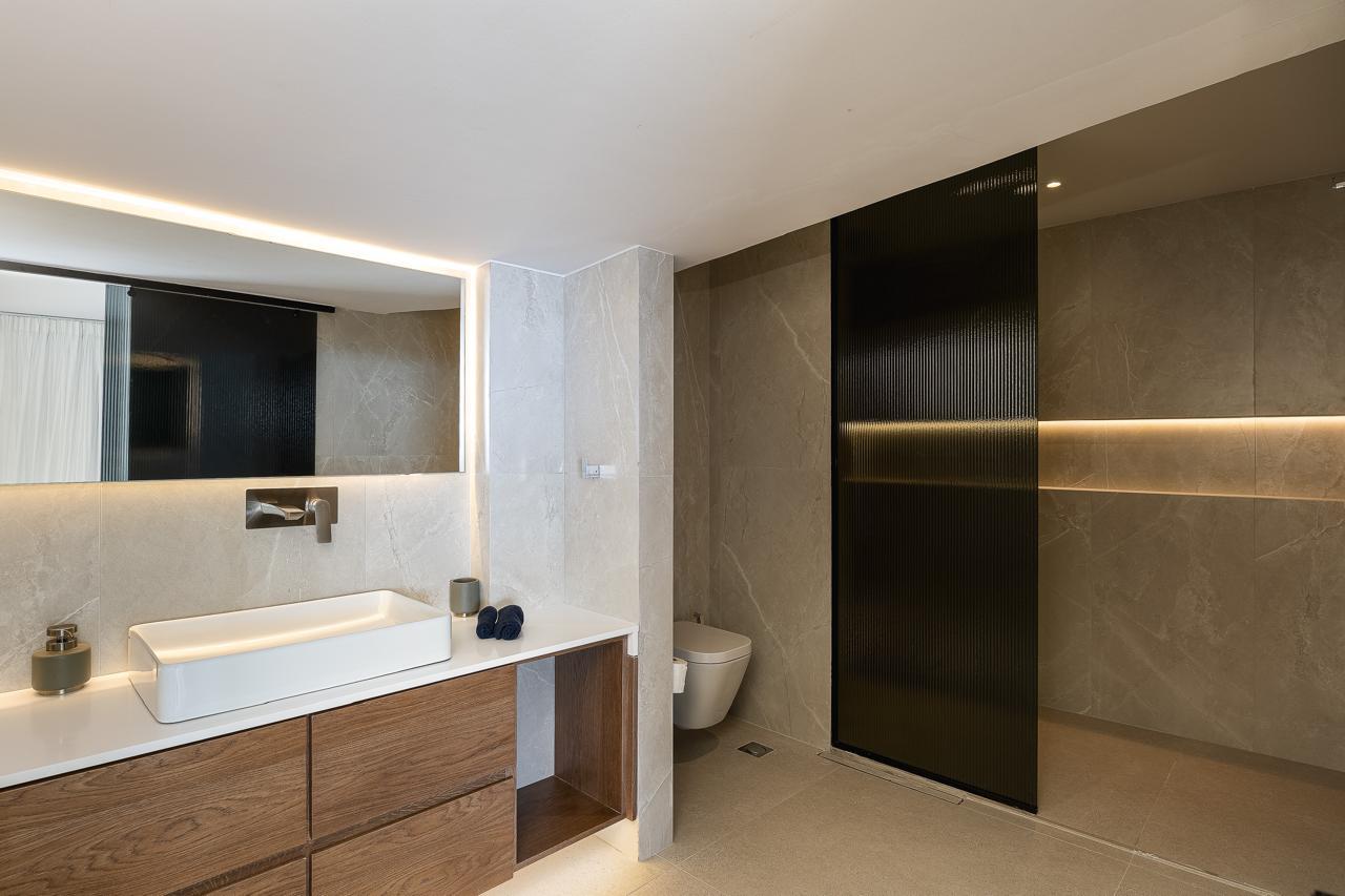 Marble ensuite with stone vanity and walk-in shower