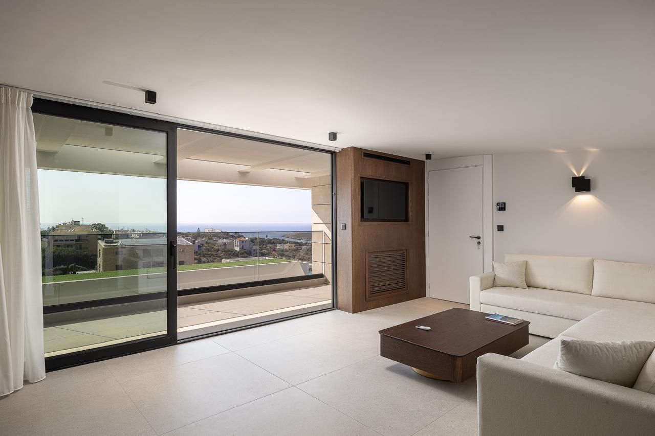 Terrace doors sliding open to the sea from the primary suite