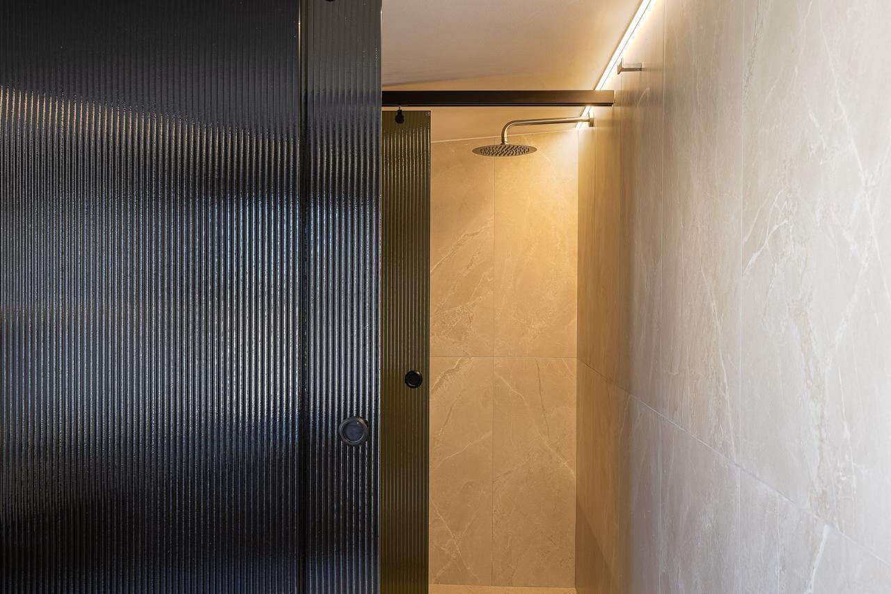 Fluted glass and marble rain shower