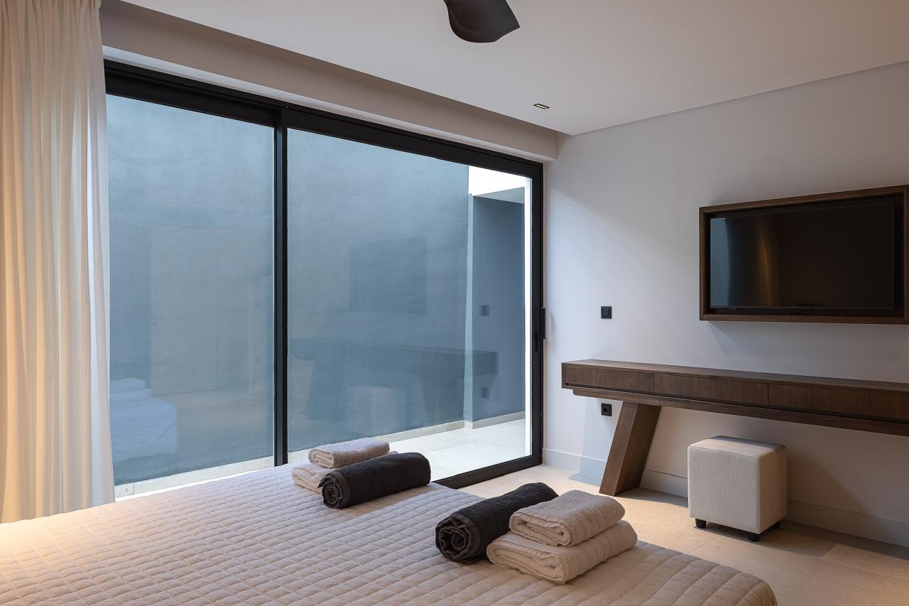 The private screened courtyard beyond the sliding glass