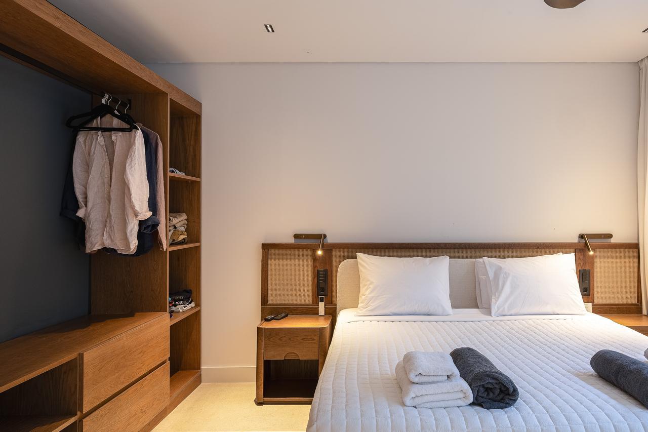 Open oak wardrobe against the charcoal wall